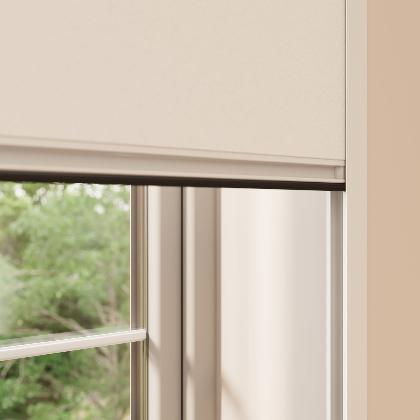 A close-up view of a window with a beige BlocOut blind. The window frame is light-coloured, and the outside scenery shows green foliage. The BlocOut blind is positioned at the top part of the window, leaving the lower part exposed to natural light.